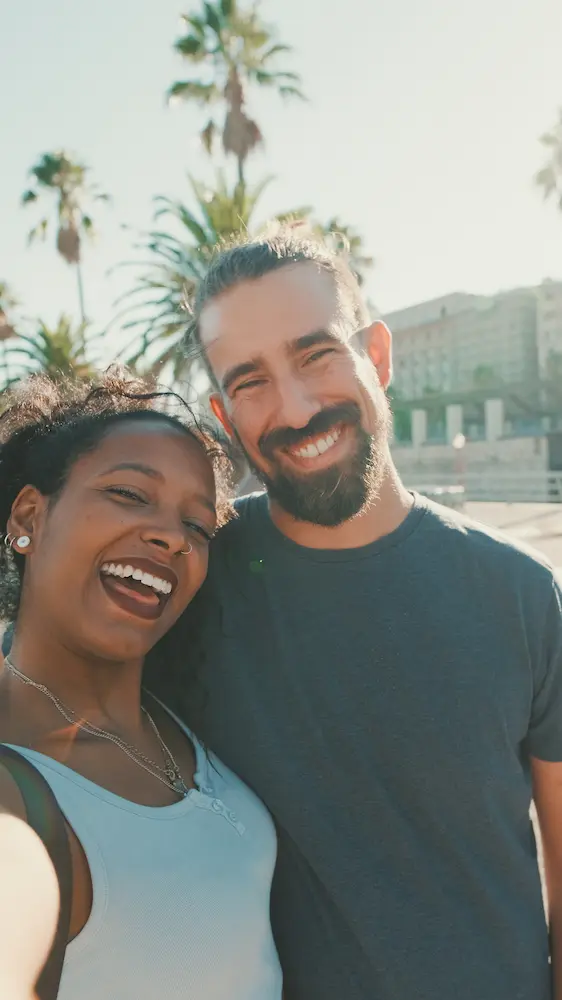 Close-up of interracial smiling couple taking selfie